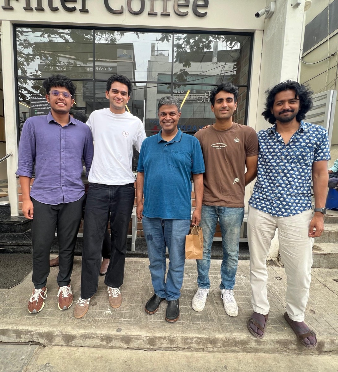 Varun Gandhi with Sarvam AI co-founder Dr. Vivek Raghavan and members of the Vision-Language Models team, standing outside a coffee shop
